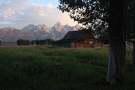 Rustic cabin in a field (Unsplash).jpg