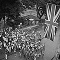 1945 - A British flag flies above a cheering crowd during the arrival of the 5th Indian Division at Singapore , which marked the end of three and a half years of Japanese occupation