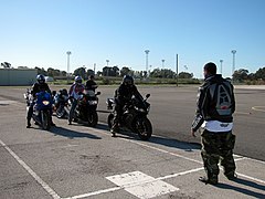 US Navy 081216-N-1825E-004 Volunteer motorcycle safety instructor Master-at-Arms 2nd Class Bradrick Hawkins instructs motorcycle riders to start their engines.jpg