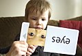 3 year-old Joey Adams identifies items from flash cards during an in-home therapy session