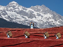 Naxi people carrying baskets