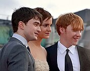 Watson with Daniel Radcliffe and Rupert Grint (7 July 2011)