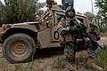 "US_Navy_060328-N-6901L-118_U.S._Army_Spc._Osvaldo_Fernandez_stands_perimeter_security_in_front_of_an_M1114_HMMWV_(Humvee)_near_the_town_of_Tarmiya,_Iraq_during_counter-insurgency_operations.jpg" by User:BotMultichillT