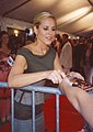 Signing the cover of a DVD version of Coyote Ugly, during Toronto Film Festival