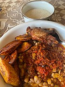 Beans and plantain with stew, fried fish and a cup of garri.jpg