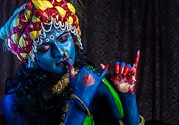 A girl dressed as Lord Krishna attends open-air theatrical performance by TAPAS KUMAR HALDER
