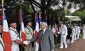 US Navy 110704-N-AG285-236 The mayor of Cannes, France, Bernard Brochand, shakes hands with official flag bearers during a memorial service honorin.jpg