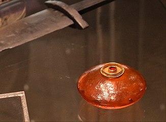 Sword bead, amber pendant with almandine embedded in a gold frame, 5th century