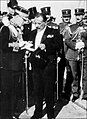 Regent Georgios Kondylis (in frock coat, centre) hands King George II the text of his speech on the latter's return from exile, Nov 1935