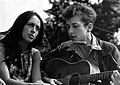 Joan Baez and Bob Dylan, who plays guitar and harmonica (1963)