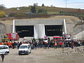 South portal of the two tubes of the Katzenbergtunnel, a rail road tunnel near Efringen-Kirchen, built to enhance the Rheintalbahn in southern Germany. The people in the picture gathered to meet the chairman of Deutsche Bahn, Dr. Rüdiger Grube, to discuss issues concerning the new railroad which is being built.