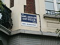 Rue Saint-Ghislain/Sint-Gislein Straat/Sinte-Gelanchstroet multilingual sign in Brussels