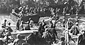 Movin off the ramp of a Coast Guard-manned landing craft, Marines move ashore on D-Day at Cape Gloucester, Operation Dexterity.