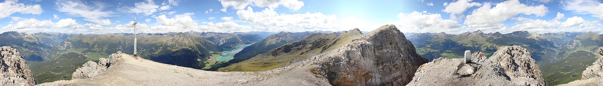 Piz Lad, a view down from the summit to lake Reschensee (mountain pass Reschenpass).