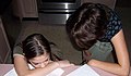 Mother and daughter studying in kitchen