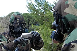 US Navy 090513-N-3289C-040 Explosive Ordnance Disposal Mobile Unit (EODMU) 8 Det. Europe, reads instructions for a chemical detection kit to Sargento-Primero Manuel Gutierrez Ramirez.jpg