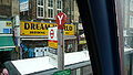 English: A bus stop outside Shepherd's Bush railway station, serving route 295. Notable is the cover over the stop, indicating that this bus stop is used for Rail Replacement bus services when Shepherd's Bush station is affected by engineering work.