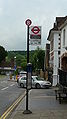English: Bus stop B on Vicarage Hill, Westerham, Kent, at Westerham Green. All of the bus routes turn off the main road onto London Road, to serve the houses, hence a pair of bus stops is needed at either side of the junction, depending on which end the bus approaches the town from. These are Transport for London bus stops, as TfL route 246 serves them, and TfL selfishly take over in this situation. It also serves routes 236, and 401 but as TfL have taken over the stop, it says "towards Biggin Hill", which is completely wrong for the 236 and 401.