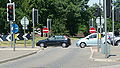 English: A piece of bus lane, over the middle of Tushmore Roundabout in Crawley, West Sussex, helping buses get past other traffic. A stretch of guided busway leads up to its northern side, and Fastway buses are able to drive over the middle to the southern side. Tushmore Roundabout is at the junction of the A23 road, and the A2011 and A2219. This is part of the Crawley Fastway guided bus system. Seen here is the exit, from the roundabout, through a connecting piece of road that joins main traffic where the photo was taken from.