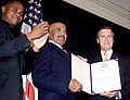 Cohen (right) with Cuba Gooding, Jr., presenting Master Chief Petty Officer Carl Brashear with Outstanding Public Service Award, October 2000.