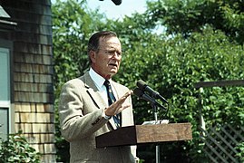 President George H. W. Bush holds a press conference in front of the "Plate House".jpg