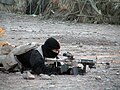 A U.S. Navy SEAL team member provides cover for his teammates.