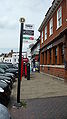 English: Bus stop D in Market Square, Westerham, Kent. All of the bus routes turn off the main road onto London Road, to serve the houses, hence a pair of bus stops is needed at either side of the junction, depending on which end the bus approaches the town from. These are Kent County Council bus stops, serving routes 410 and 694. Since new Surrey County Council contracts started, route 410 has been curtailed at Oxted, replaced to Westerham by routes 594 and 595. This was after Southdown PSV won the contract for the routes from Metrobus, and as they already ran the 410, they were able to shuffle things around slightly. The bus stop is unusually situated on the pavement, with cars able to park beside it, so the bus cannot actually pull into the bus stop.