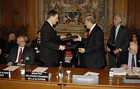 Samuel Žbogar and José Ángel Gurría signing the OECD agreement.jpg