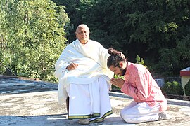 A student pays Namaste to a Yoga master in India