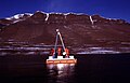 Sediment sampling with a piston coring system from a raft, Basalt lake, Greenland