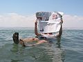 Man afloat in the Dead Sea, reading a newspaper.