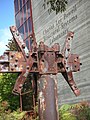 Corroded industrial sculpture displayed outside UCSD's Powell Sructural Systems Laboratory.