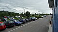 English: Park of the car park at the London Road park and ride site, in Salisbury, Wiltshire, which is served by route 504. The site is unusual in that the waiting room is sited by the main road - passengers park in the car park and walk up to the waiting room. Buses do not enter the site, instead turning on a roundabout and using a simple layby to stop in. The only downside is that while you wait for the bus, a constant stream of noisy traffic goes past.