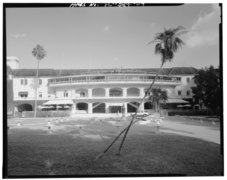 West facade of clubhouse. Showing first and second floor loggais - Clubhouse Verandah and citation statue in foreground- CD-E. - Hialeah Park Race Track, East Fourth Avenue, HABS FLA,13-HIAL,1-9.tif