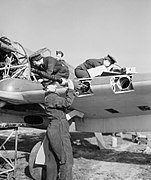 WAAF armourers and flight mechanics servicing a Hawker Hurricane at Sealand in Wales, 5 May 1943. CH10090.jpg