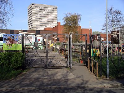 Coventry City Farm gate, veiw includes high rise flats of Hillfields in the background