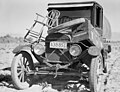 Car of drought refugee on edge of carrot field in the Coachella Valley, California, spring 1937