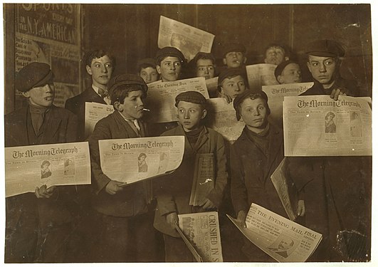 "2_A.M._February_12,1908._Papers_just_out._Boys_starting_out_on_morning_round._Ages_13_years_and_upward._At_the_side_door_of_Journal_Building_near_Brooklyn_Bridge._LOC_cph.3b01716.jpg" by User:Fæ