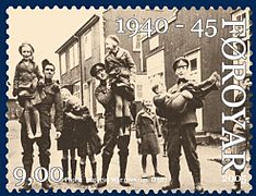 Ein vinalig herseting - A Friendly Occupation: British soldiers playing with Faroese kids during World War II - Faroese stamps 2005.
