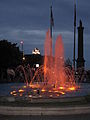 A fountain lit up by colourful lights at night in Old Montreal.