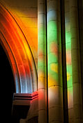 Reflections of stained glass windows in the nave.