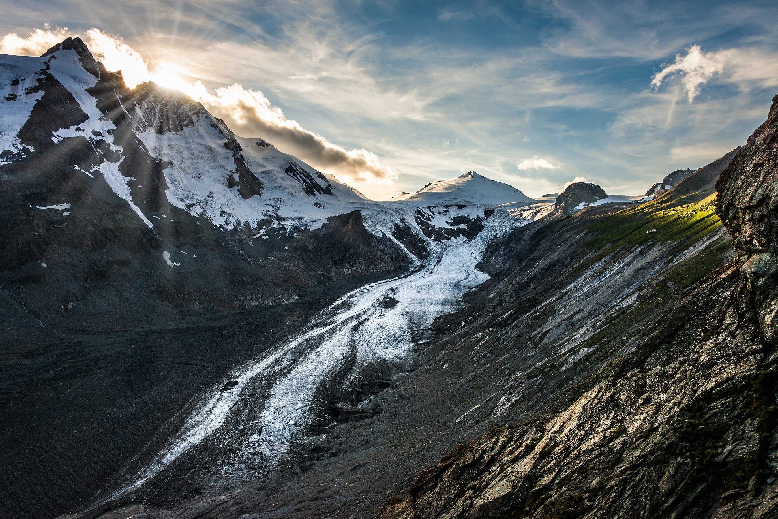 The Pasterze, the longest glacier in Austria, lies within the Hohe Tauern mountain range in Carinthia. The summit on the left side of the image is the Grossglockner, Austria's highest mountain (3,798 m = 12,461 ft). Due to global warming, the Pasterze, once a proud glacier filling the valley, is rapidly fading away. Actually, the Pasterze is the fastest-dying Glacier in the Alps. In 2013 it lost about 100 meters of its length, by Bernd Thaller