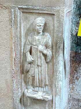 Roman tombstone showing a celtic farmer´s woman at the entrance of the crypt.