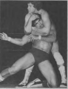 Roddy Piper applying a sleeperhold on Ricky Steamboat, circa 1982.png