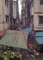 Vegetable booth in downtown Yangon, northern 49th Street in front of Ye Kyaw Market, August 2013, backyard in the background