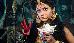 Woman dressed as Sherawali, the warrior goddess who rides a tiger, by TAPAS KUMAR HALDER