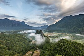 Karst peaks mist and colorful clouds at sunrise seen from Mount Nam Xay in Vang Vieng Laos.jpg