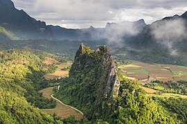 Green karst peaks seen from the top of Mount Nam Xay a sunny morning with fog Vang Vieng Laos.jpg