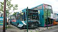 English: Arriva The Shires 3841 (N621 FJO) (left), a Volvo B10B/Plaxton Verde, and (right) 5118 (G288 UMJ), a Leyland-bodied Leyland Olympian. Both are parked on "death row" at Arriva's High Wycombe depot, for buses with problems. 5118, being a rather elderly double-decker, has probably with withdrawn due to its age, and has since gone for scrap. Rather visibly, 3841 had been involved in a very serious accident with a motorbike. These Verdes seem to be cursed. Sister 3855 was repainted and was destroyed by fire soon afterwards, and 3841 was repainted and had a serious accident.