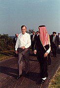 President George H. W. Bush walks along the driveway at Walker's Point, Kennebunkport, Maine, with Saudi Foreign Minister Prince Saud Al-Faisal.jpg